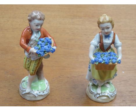 PAIR OF DRESDEN HANDPAINTED AND GILDED CERAMIC FIGURES DEPICTING LADY AND GENT WITH BASKET OF FLOWERS, APPROXIMATELY 12cm HIG