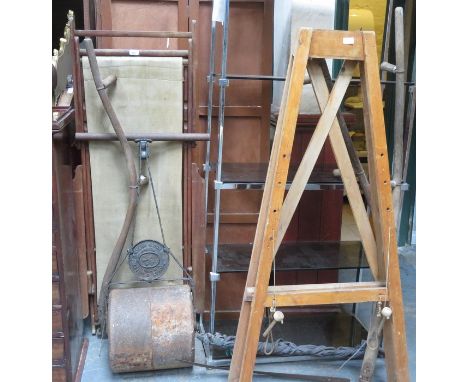 CAST IRON FRAMED ROLLER AND DECK CHAIR, SYTHES AND ARTIST'S EASEL 