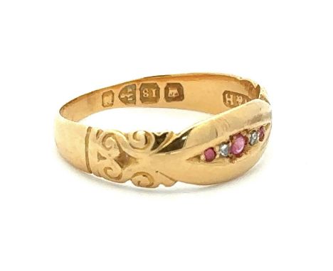 A late Victorian 18ct gold ring with scroll shoulders set with five stones, rubies and diamonds, Chester hallmarks 1891. Size