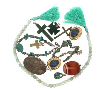 A number of pieces of hardstone jewellery including a nephrite cross pendant with gold mount stamped 14K, a string of jade be