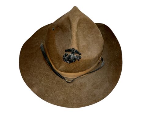 A USMC United States Marine Corps drill campaign hat. Heavy felt construction with typical x4 dent style top and US cap badge