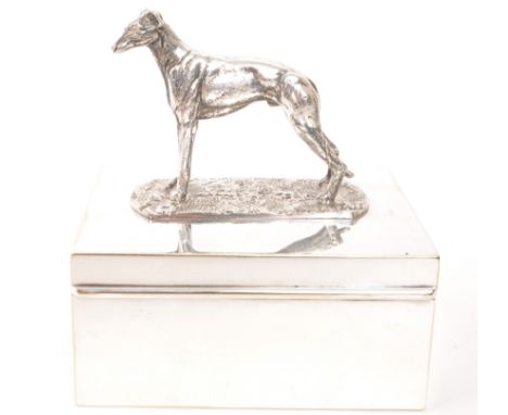 A vintage 20th century greyhound top silver plate cigarette holder. With greyhound dog to top, on rectangular sit on lid, rev