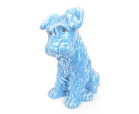 A vintage 20th century ceramic pottery figurine / statue of a terrier dog in the Sylvac manner. In a seated position, in a bl