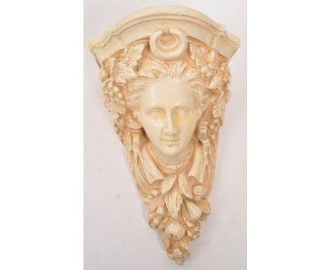 A cast plaster wall scone of the Etruscan goddess Minerva. The sconce featuring a relief portrait to front of the Etruscan go