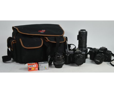 Nikon - Two late 20th century Nikon 35mm SLR cameras and lenses. The collection to include Nikon F401 and F601 camera bodies,