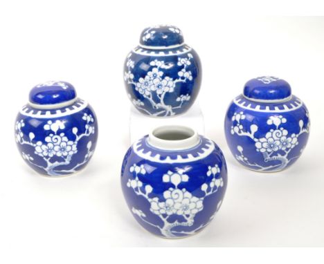 A collection of four late 20th Century Chinese ceramic ginger jars having prunus design in blue and white colourway. Three wi