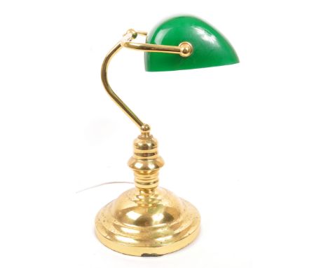 A mid 20th Century vintage bankers table top desk lamp light. Having green glass lightshade supported by brass arm raised on 