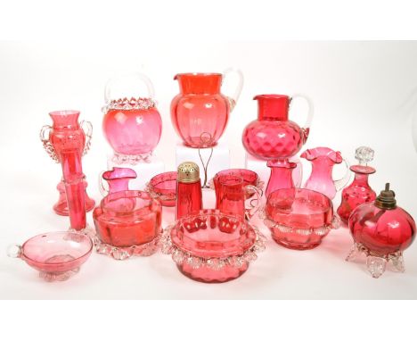 A large collection of mid Century vintage cranberry glassware items to include jugs, bowls, vases, basket, teacup, urn shaped