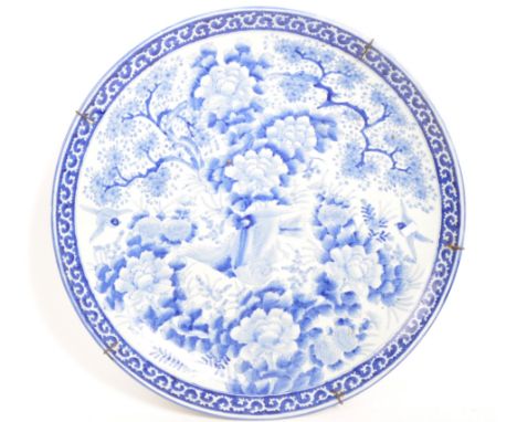 A large early 20th century blue and white Japanese ceramic charger display plate. 55cm diameter. With floraL and foliate desi