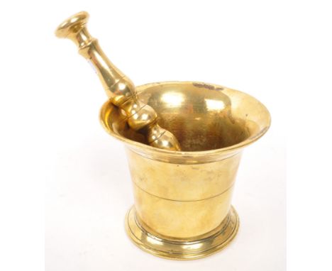 A vintage 20th brass pestle and mortar. With a baluster shaped pestle and tapering circular mortar. Measures 9cm x 11cm diame