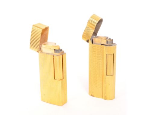 Dunhill / Saffa - Two mid 20th century gold plated pocket cigarette lighters. Each lighter having an engine turned gold plate