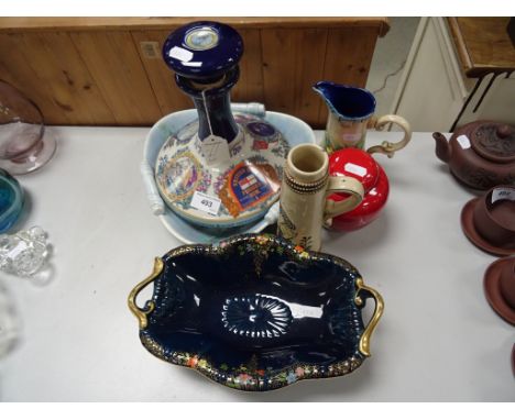 A Crown Devon two handled centre piece on a blue ground, with enamelled flowers and gilded handled, along with other items 