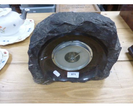 A barometer set in granite surround 