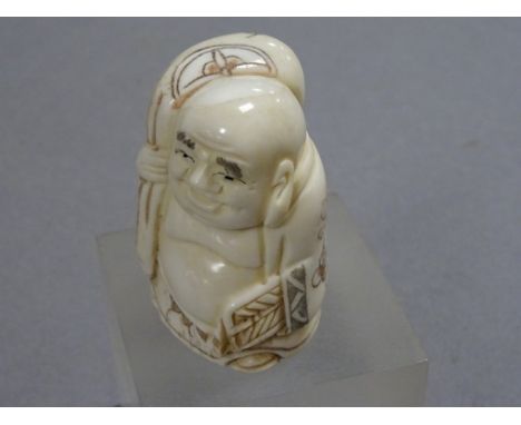 Signed oxbone netsuke of a Man with sack