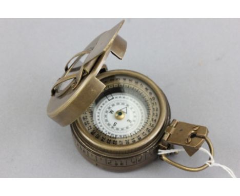 Brass compass stamped TG Co Ltd London 1940, with crows foot mark