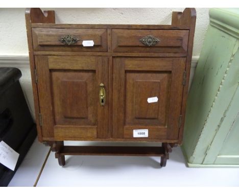 A late Victorian hanging shelf unit with two doors over two drawers