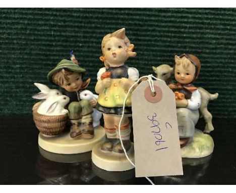 Three Hummel figures - boy with rabbits etc 