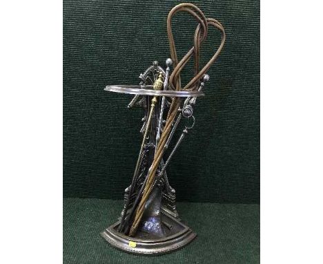 An early 20th century chrome corer stick stand with carpet beater and companion set 