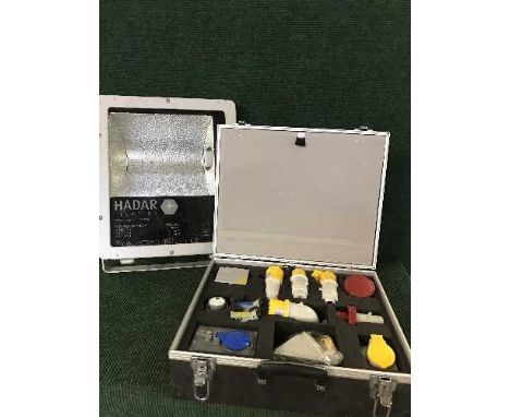An industrial site light, halogen spot light and an aluminium case of accessories 