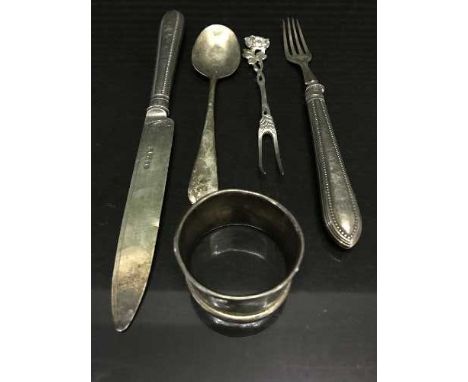 A silver knife and fork, silver pickle fork, napkin ring and teaspoon