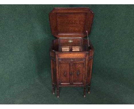 A carved oak gramophone cabinet 