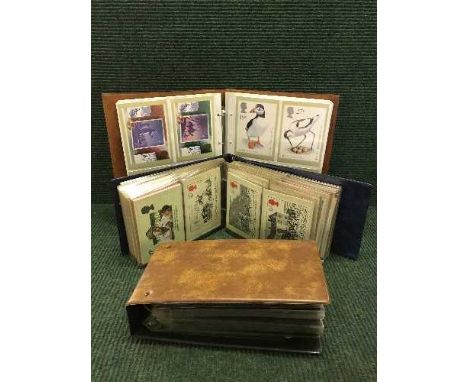 Three albums of Royal Mail first day covers and stamp postcards 