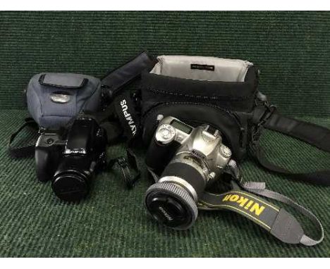 A cased Nikon D 50 camera with lens and Olympus IS-1000 camera 