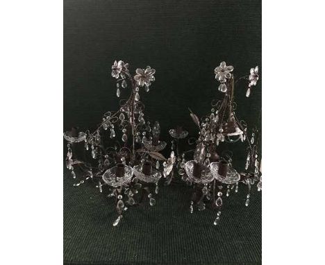A metal six way light fitting together with two metal lights with glass drops