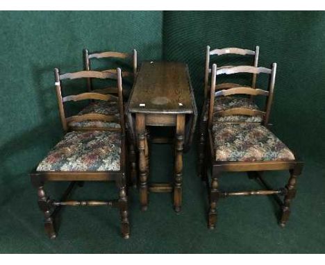 A narrow oak gate leg table and four chairs 