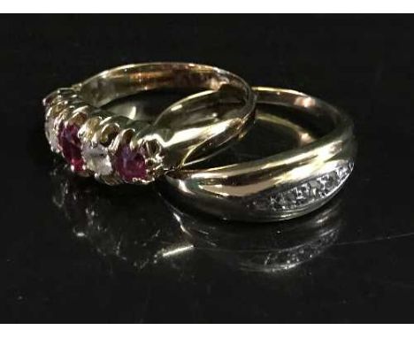 An 18ct gold ruby set ring together with a three stone diamond ring. (2)