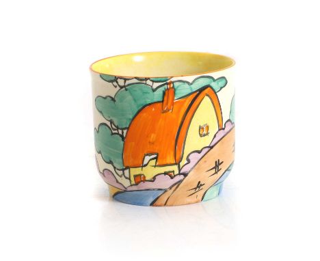 A Clarice Cliff 'Orange Roof Cottage' pot, c.1930s, hand-painted in enamels with an orange-roofed cottage by a bridge, marked