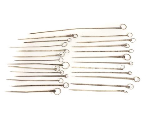 A collection of twenty five silver game skewers, 18th and 19th century, French, of tapering needle form, of various sizes, wi