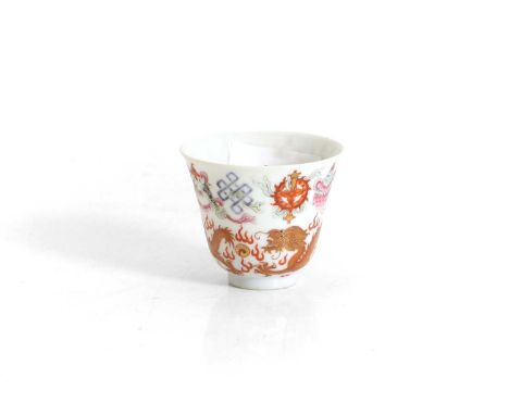 A Chinese famille rose cup， painted with dragons in iron red chasing flaming pearls, below Eight Buddhist Emblems, with a six