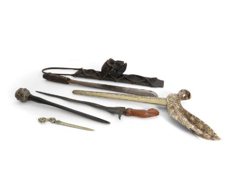 A Kris ceremonial sword and scabbard,  the scabbard decorated with elephants, rhinos, and crocodiles, the sword 47cm long, a 