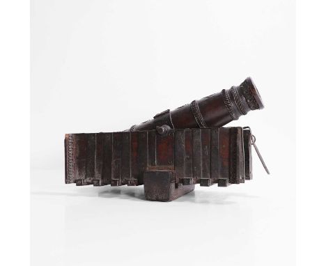 An Anglo-Indian carved wood model of cannon, late 19th/early 20th century, of typical form, with carved bands and an elephant