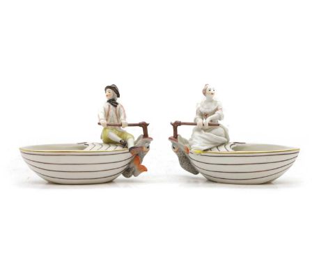 A pair of Nymphenburg boat-shaped bowls, modelled after Frankenthal models, one with a man and one with a woman at the tiller