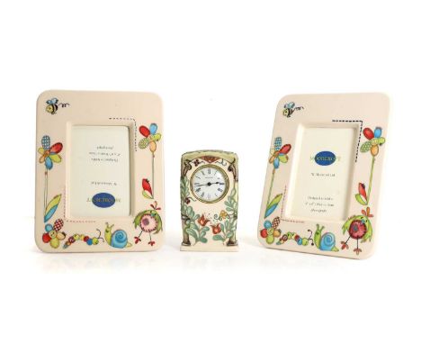 Two Moorcroft Pottery nursery photograph frames, 'Stitch in time', by Nicola Slaney, 25.5 x 20cmtogether with a Moorcroft pot