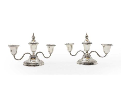 A pair of silver dwarf candelabra, by Adie Brothers, Birmingham 1948, with reeded scroll arms, each with three sockets and on