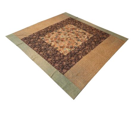 A printed cotton quilted throw, late 19th/early 20th century, constructed using French fabric, the central field decorated wi