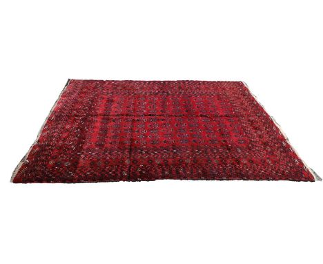 A Turkoman wool rug, 20th century, with repeating motifs to a brick red field within a multi border,315 x 226cmCondition Repo