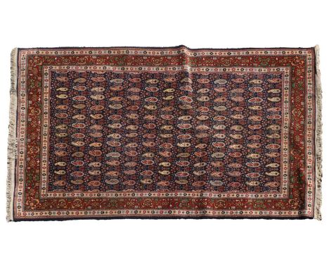 A Turkish Hereke rug, 20th century, with repeating guls to a navy border within a multi border with stylished foliage,250 x 1