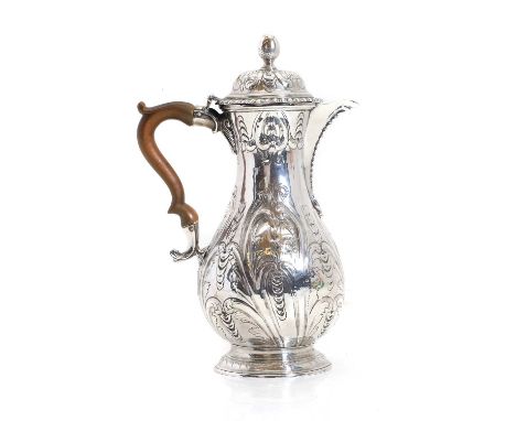 A George II silver hot water jug, by Thomas Heming, London 1751, of baluster form, with acorn finial, above a gadrooned edged