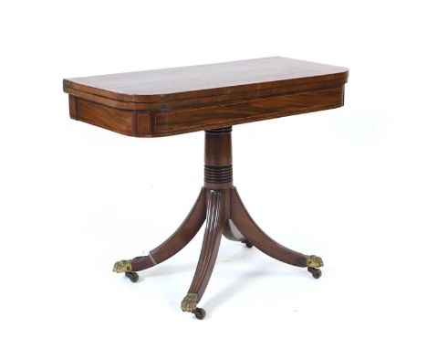 A Regency mahogany card table, c.1810, the foldover top with canted corners, and satinwood crossbanding, opening to reveal a 
