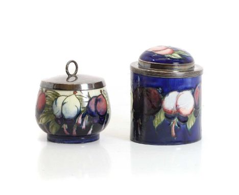 A Moorcroft 'Wisteria' pattern pepper pot, impressed 'Moorcroft, Made in England', and '101',9cm high,together with a Moorcro
