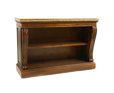 A George IV style mahogany open bookcase, 20th century, the granite top, above a single shelf, flanked by acanthus capped pil