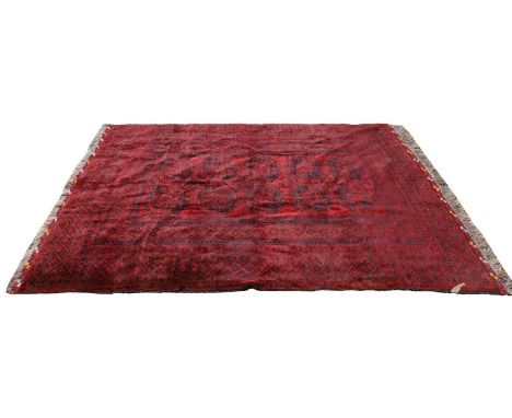 A Bokara carpet, 20th century, with repeating guls heighted in navy and dark green to a red field, within a multi border,310 