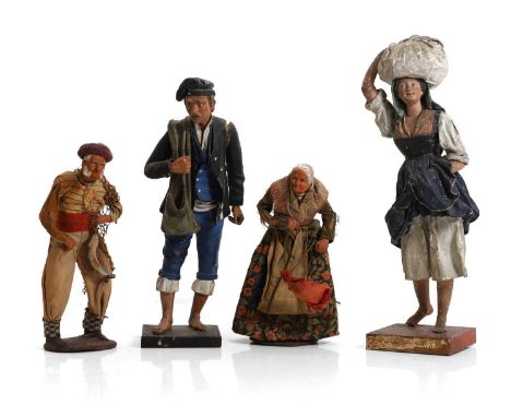 A pair of carved wood, gesso and clay artisan figures, Italian, c.1910, painted in traditional costume, on square plinth base