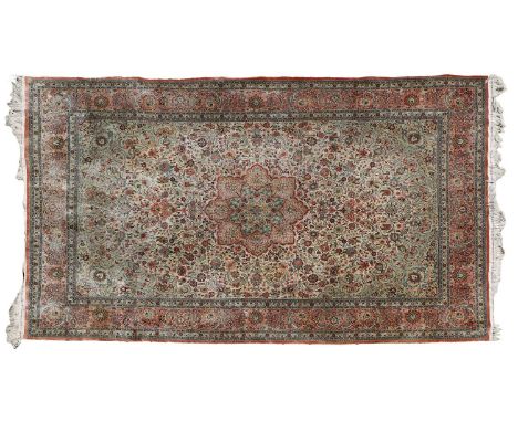 ​​A Chinese silk carpet, 20th century, with a Persian style design and tasselled ends,294 x 187cmCondition ReportOne side sli
