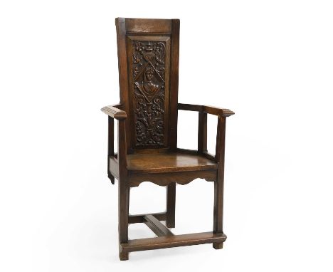 A carved oak Caqueteuse type chair,  19th century, with inset carved panel back decorated with a maiden surmounted by an urn,