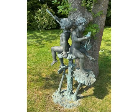 A bronze fountain, 20th century, modelled as two putto, seated on flowers, holding a horn and a frog and a fish, inscriubed '